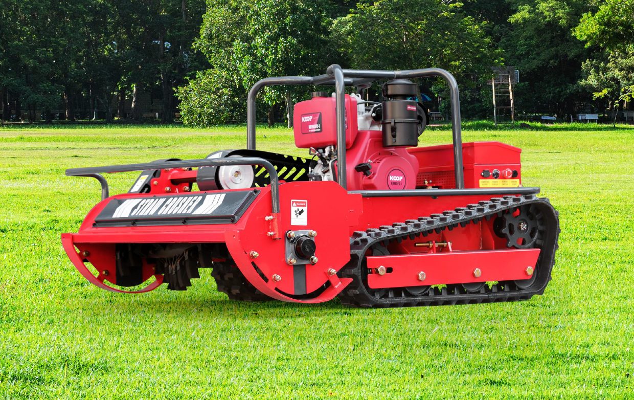 HYGC1200S remote control mower parked on open, mowed turf with trees behind it